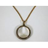 A 19thC. gold & natural pearl mourning pendant wit