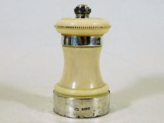 An antique silver mounted ivory pepper mill