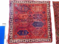 A late 19thC. wool Persian rug 38in x 37in