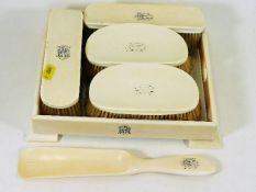 An early 20thC. ivory dressing table set with glass bottomed tray carrying HRH monogram