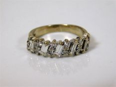 An 18ct gold ring set with baguette & round diamon