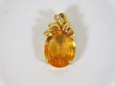 A 14ct gold mounted citrine pendant set with two s