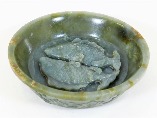 An antique Chinese carved jade style bowl with carved twinned fish decor & similar petals outside, a