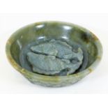 An antique Chinese carved jade style bowl with carved twinned fish decor & similar petals outside, a