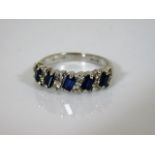 An 18ct white gold baguette cut sapphire & diamond