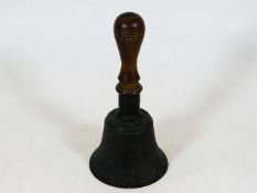 An early 20thC. hand bell with walnut handle