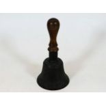 An early 20thC. hand bell with walnut handle