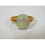 An early 20thC. 18ct gold ring set with large opal