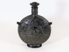An antique French pewter moon flask depicting pig