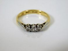 An 18ct gold diamond trilogy ring with platinum mo