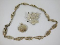 A silver necklace, silver locket & leaf brooch