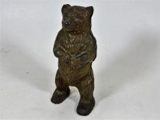 A c.1900 cast iron bear money box