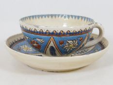 A Swiss pottery majolica cup & saucer by Thoune