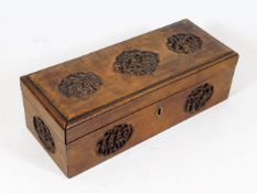 An antique Chinese wooden box with carved roundels