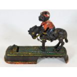 A c.1900 monkey on mule cast iron animated money b