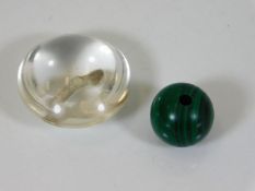 A polished crystal button twinned with malachite b