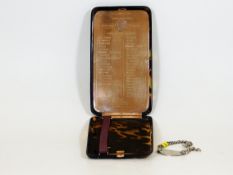 A tortoiseshell cigarette case inlaid with large 9ct gold plaque with inscription presented to E. M.