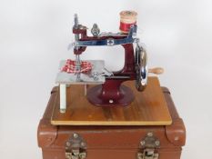 A cased childs sewing machine