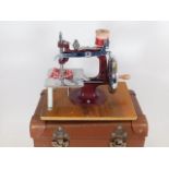 A cased childs sewing machine