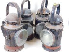 Four metal railway lamps