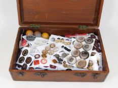 A mahogany case of collectable buttons including s
