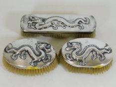 Three antique Chinese silver brushes featuring dra