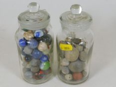 Two jars of antique marbles