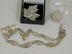 A silver necklace & two other silver jewelry piece