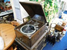 An HMV oak record player with records