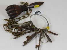 A carved hand nutcracker twinned with antique keys