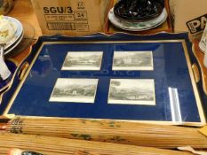 An early 20thC. glazed tray with framed postcards