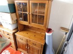 A small glazed modern pine kitchen dresser with cu