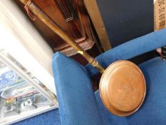 A copper bed warming pan with willow pattern desig