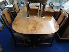 A walnut veneer drop leaf table with four chairs