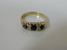 A 9ct gold sapphire ring set with small diamonds