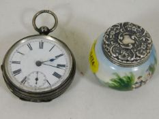 A silver pocket watch twinned with a silver topped