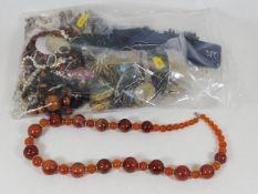 A polished agate necklace twinned with a bag of ot