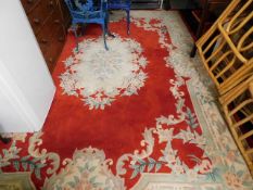A large Chinese woollen rug & two smaller