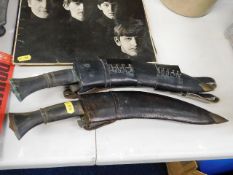A leather cased early 20thC. kukri knife & one lat