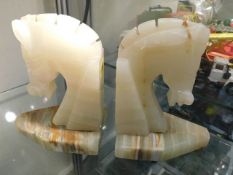 A pair of onyx horse head book ends