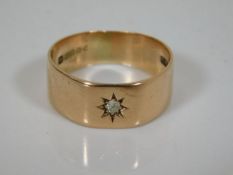 A 9ct gold band set with diamond