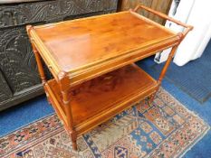 An early 20thC. yew wood style trolley with integral tray & drawer with brass wheels