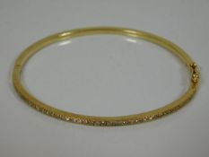 A fine 18ct gold & diamond bangle