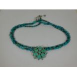 A silver mounted turquoise necklace