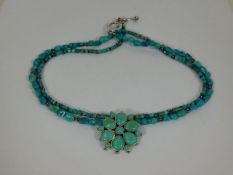 A silver mounted turquoise necklace