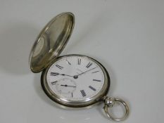 An antique silver full hunter pocket watch with duplex movement