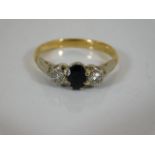 An 18ct gold ring with diamond & sapphire