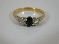 An 18ct gold ring with diamond & sapphire