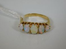 An 18ct gold antique five stone opal ring