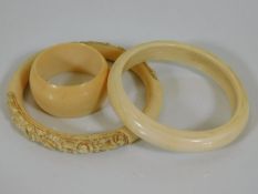Two early 20thC. bangles, one carved twinned with